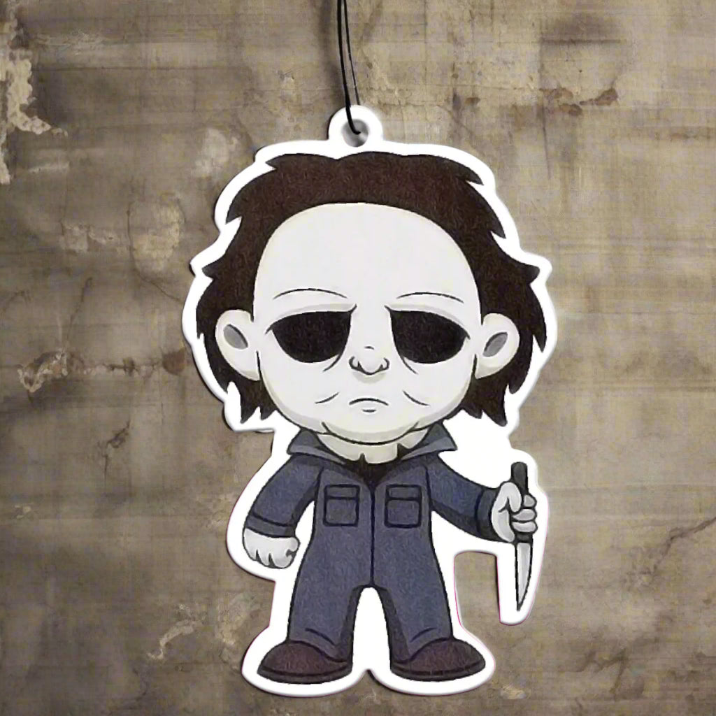 Cartoon character air freshener with a knife hanging from a car's rearview mirror.