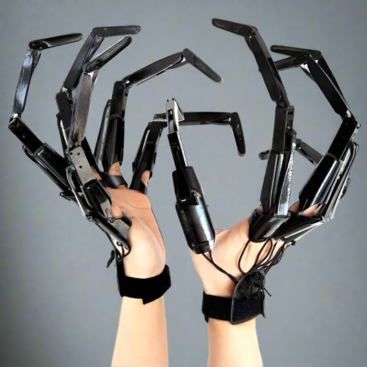 Black claw-like gloves on hands against a white background