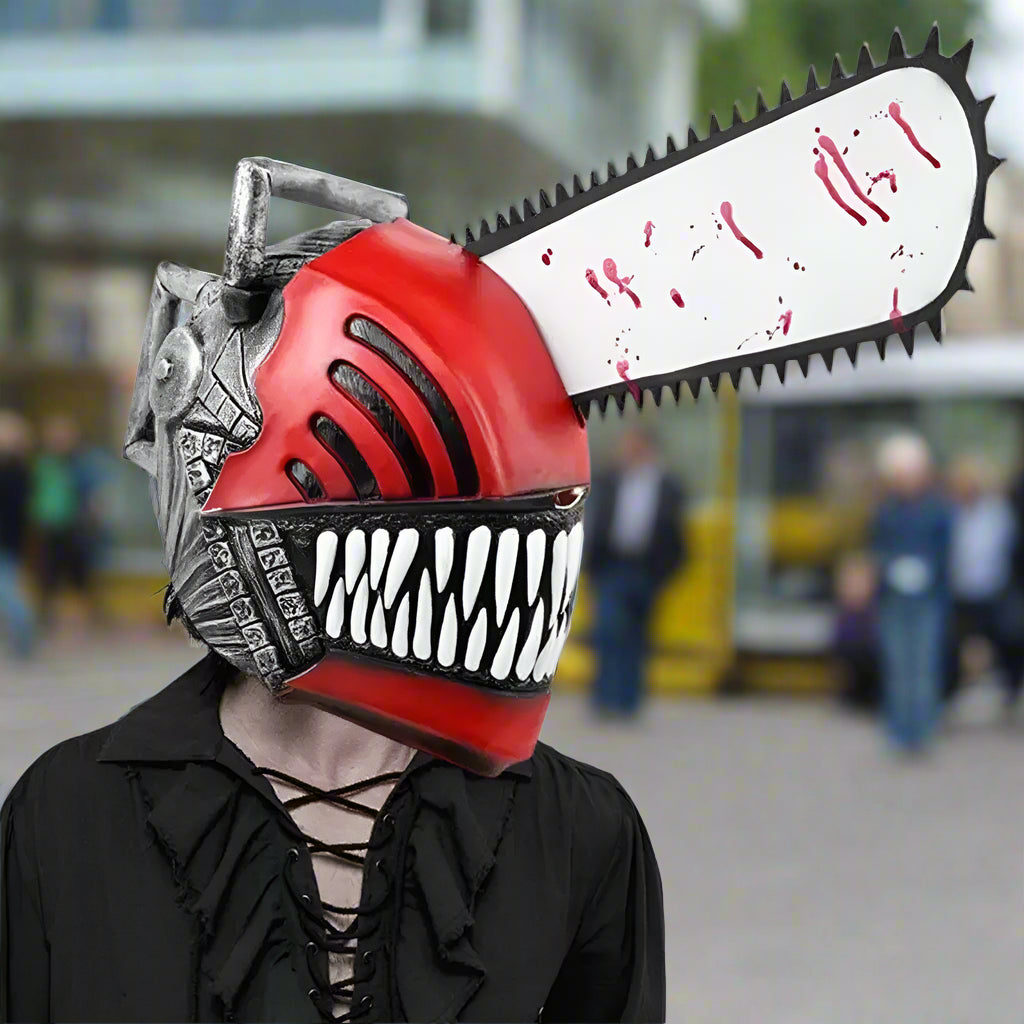 Person wearing a red and black mask with a chainsaw attachment on a white background