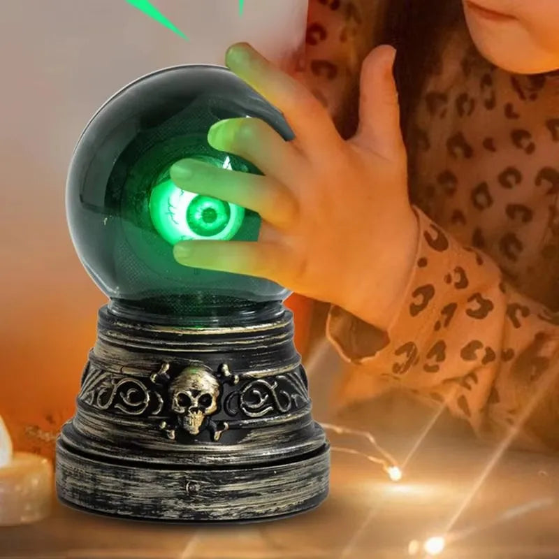 Hand reaching into a glowing green crystal ball with decorative base