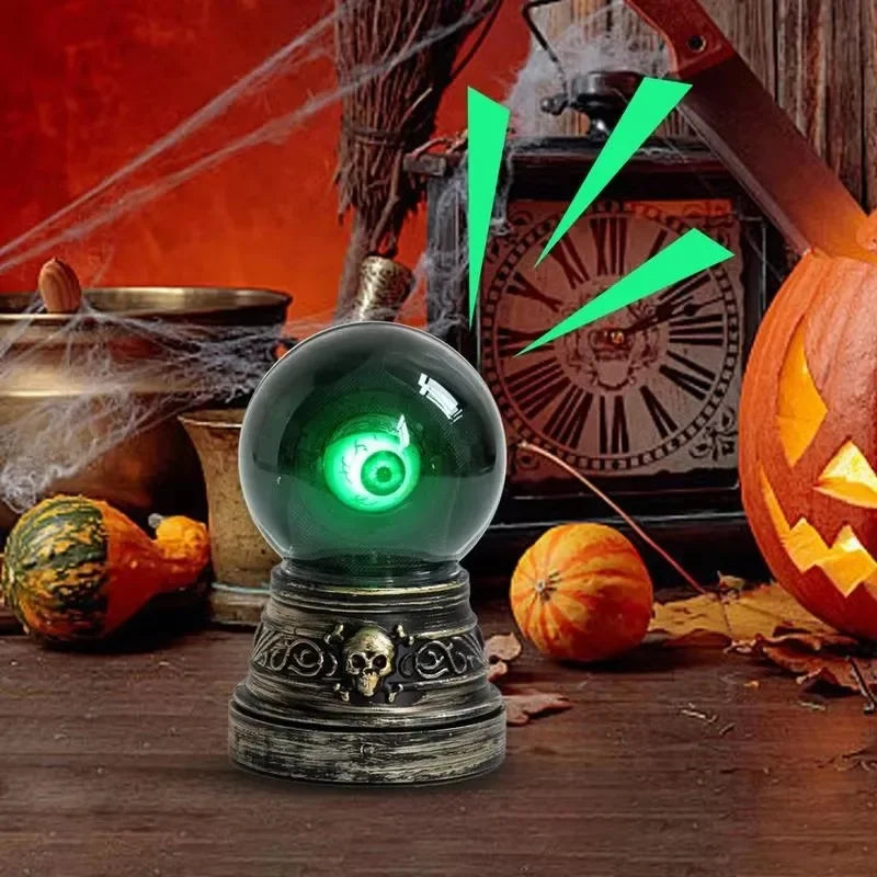 Halloween-themed crystal ball with green light on a wooden surface with pumpkins and a clock in the background.