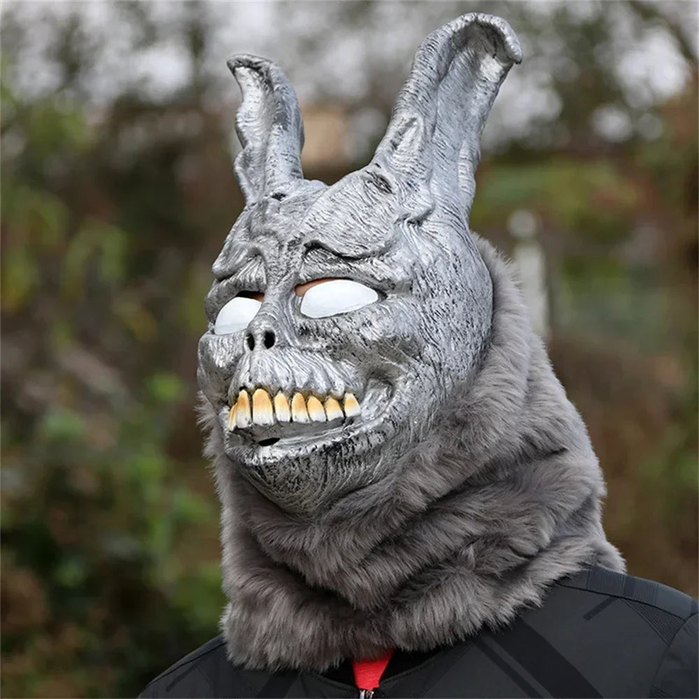 Gray furry mask with rabbit-like features and a blurred natural background