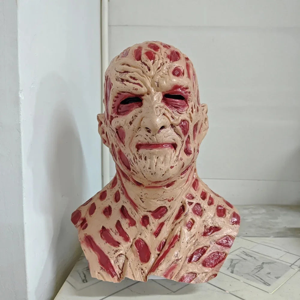 Detailed sculpture of a human-like figure with red and beige skin on a white surface.