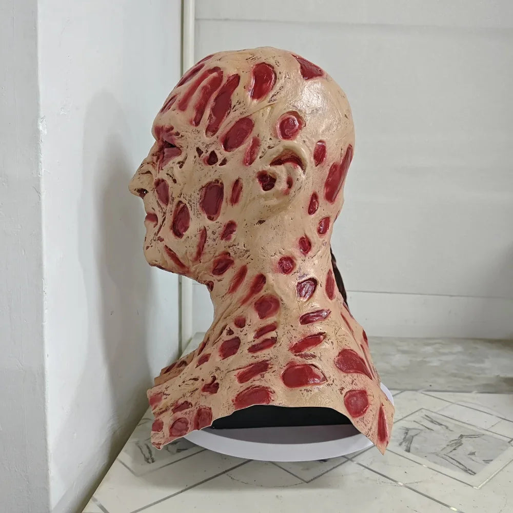 Model of a human head with red markings on a white surface