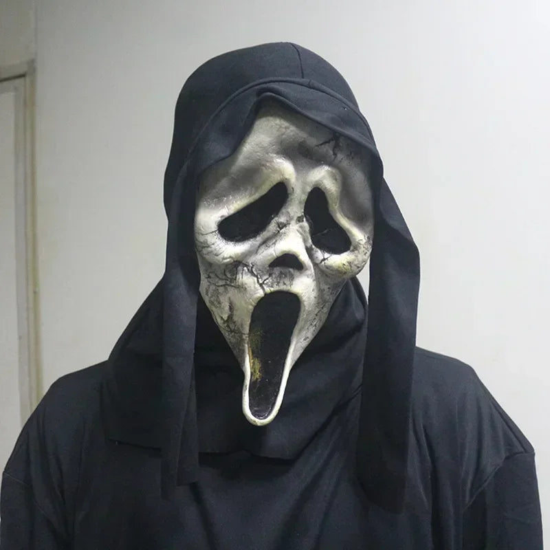 Person wearing a dark hooded garment and a iconic mask with a wide open mouth.