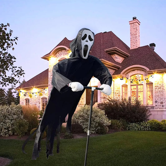 Halloween decoration of a ghostly figure with a mask in front of a house with Halloween lights.