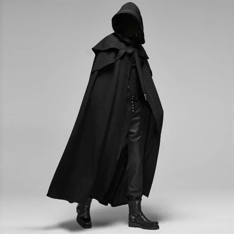 Black hooded cloak worn by a person on a gray background