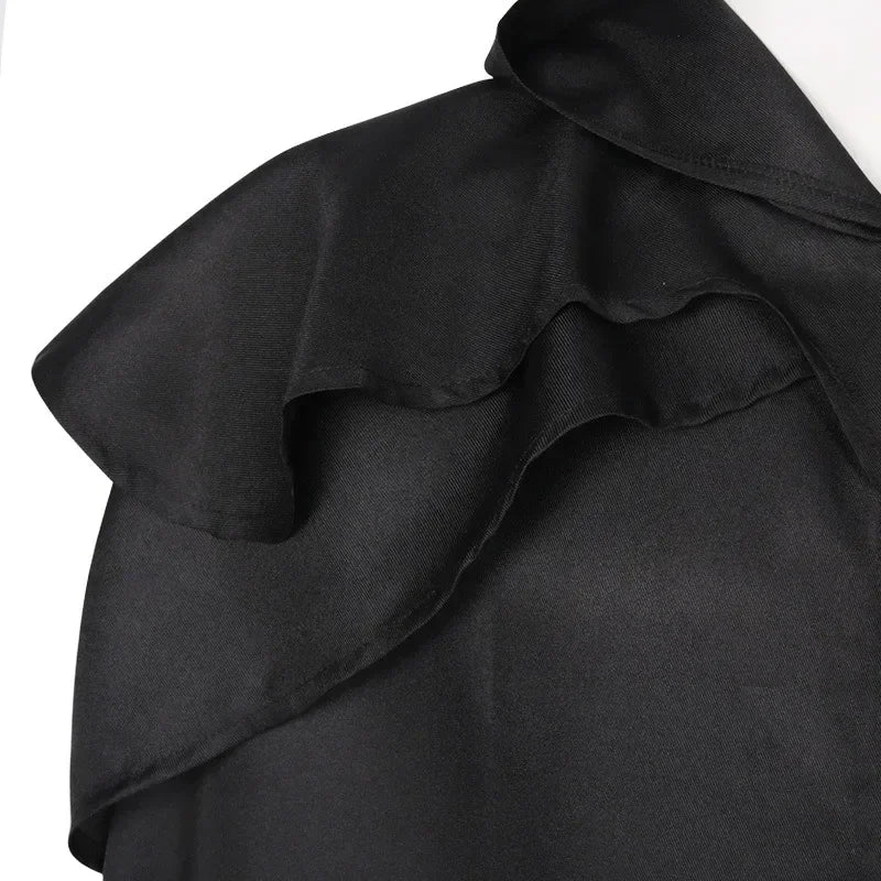 Black fabric with ruffled details on a white background