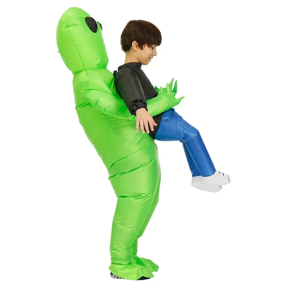 Child in a green inflatable alien costume on a white background