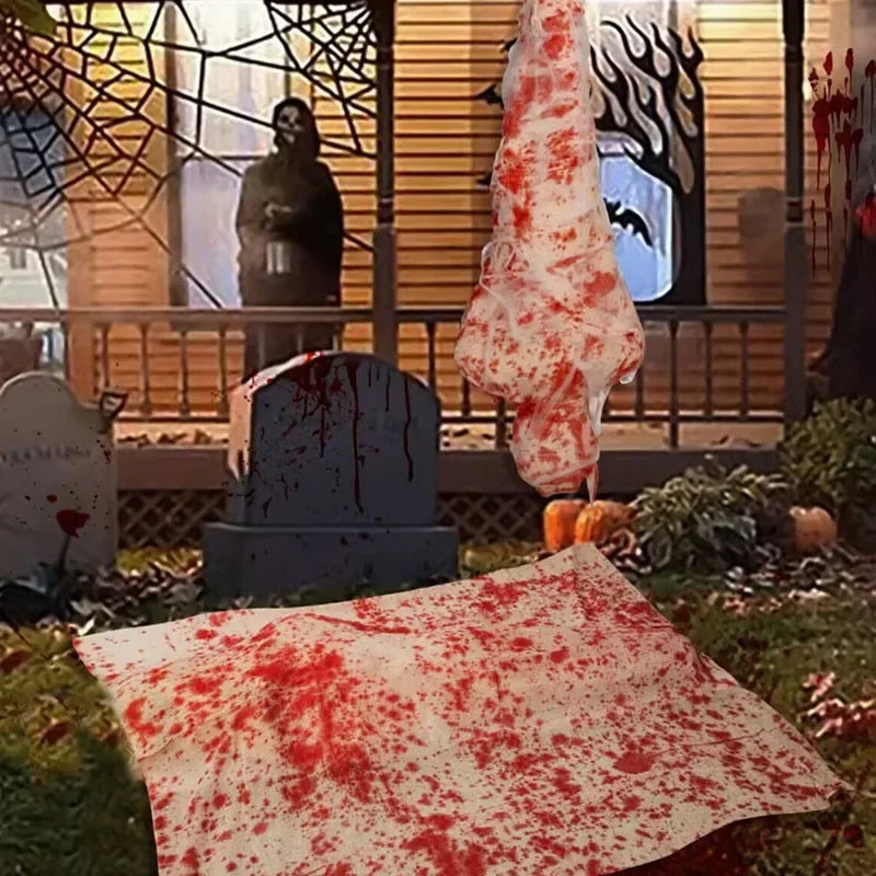 Halloween-themed outdoor decoration with a Bloody Sheet, tombstones, and pumpkins.