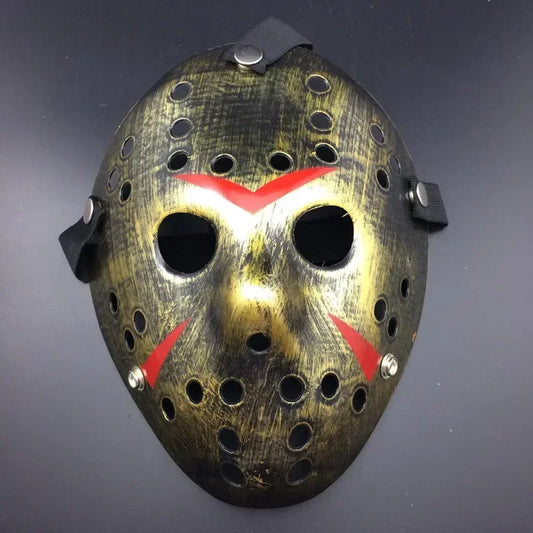 Halloween mask with a metallic gold finish and red accents on a dark background