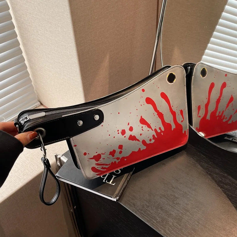Handbag with red and white design resembling blood splashes on a stand.