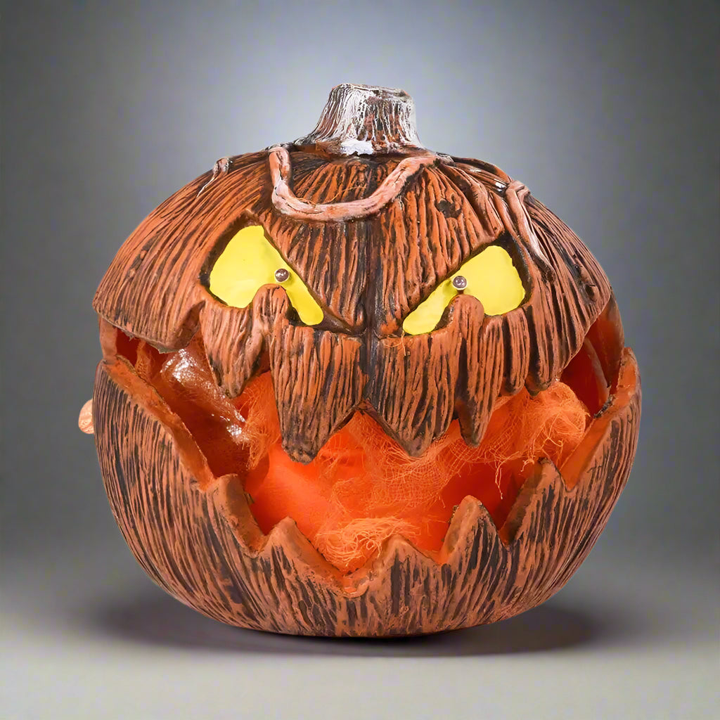 Halloween-themed coconut with carved face on a white background