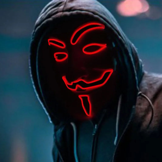 Person wearing a hooded garment with a red neon mask against a blurred background