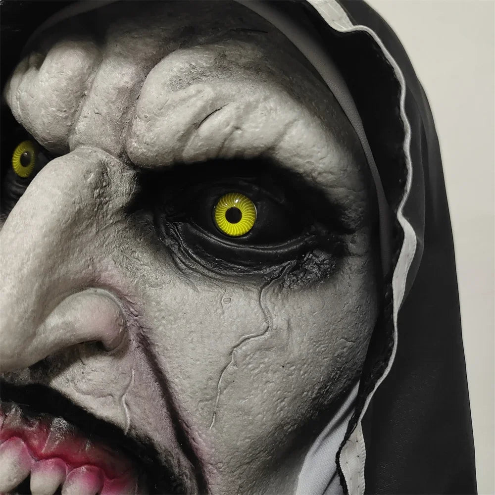 Close-up of a character with yellow eyes and a dark hooded garment.