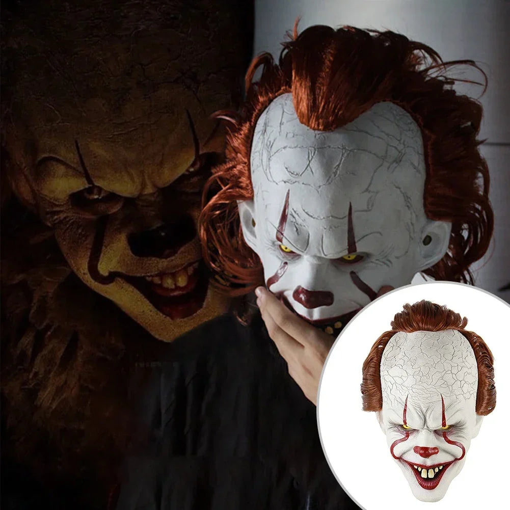 Clown mask with detailed features held by a hand, with another mask in the background.