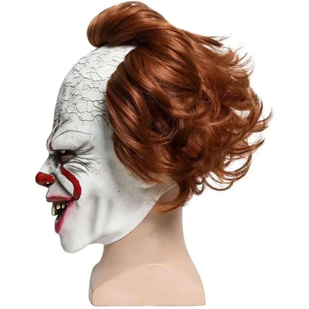 Clown mask with red hair on a mannequin head against a white background