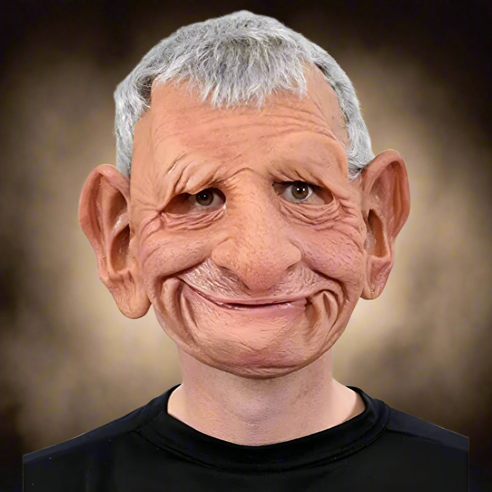 Person wearing a detailed mask with gray hair and a black shirt on a white background