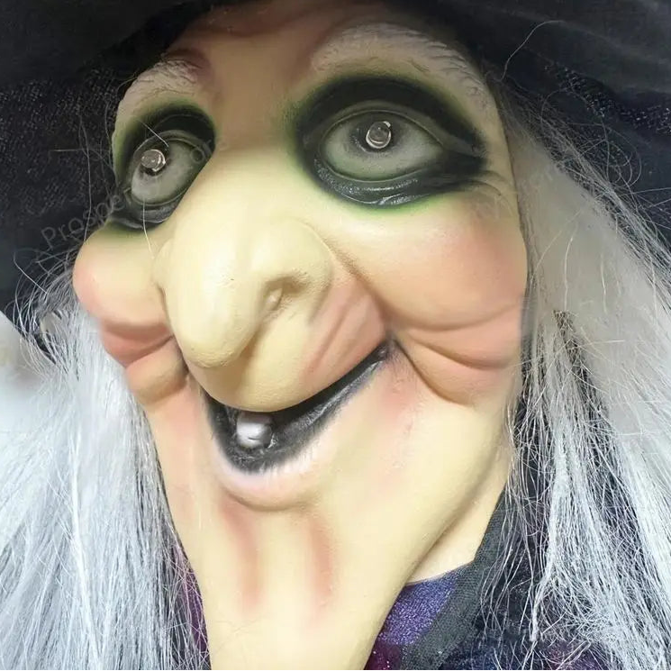 Close-up of a witch mask with detailed features and white hair.
