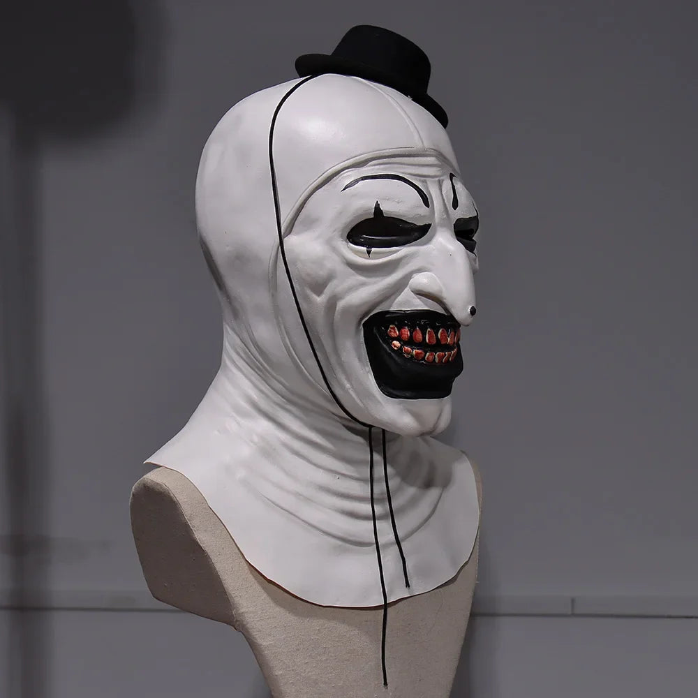 White mask with black accents on a mannequin head against a gray background