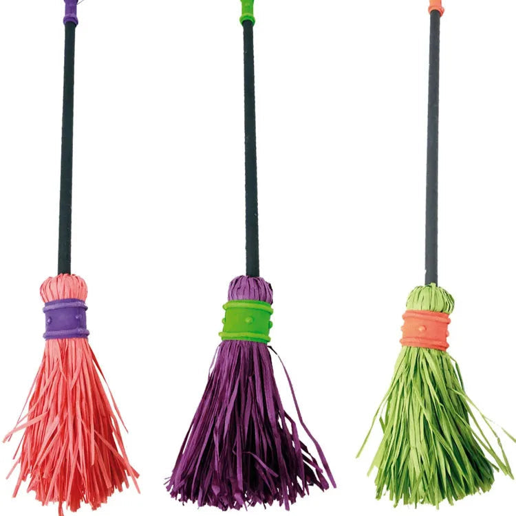 Three colorful broom toys on a white background