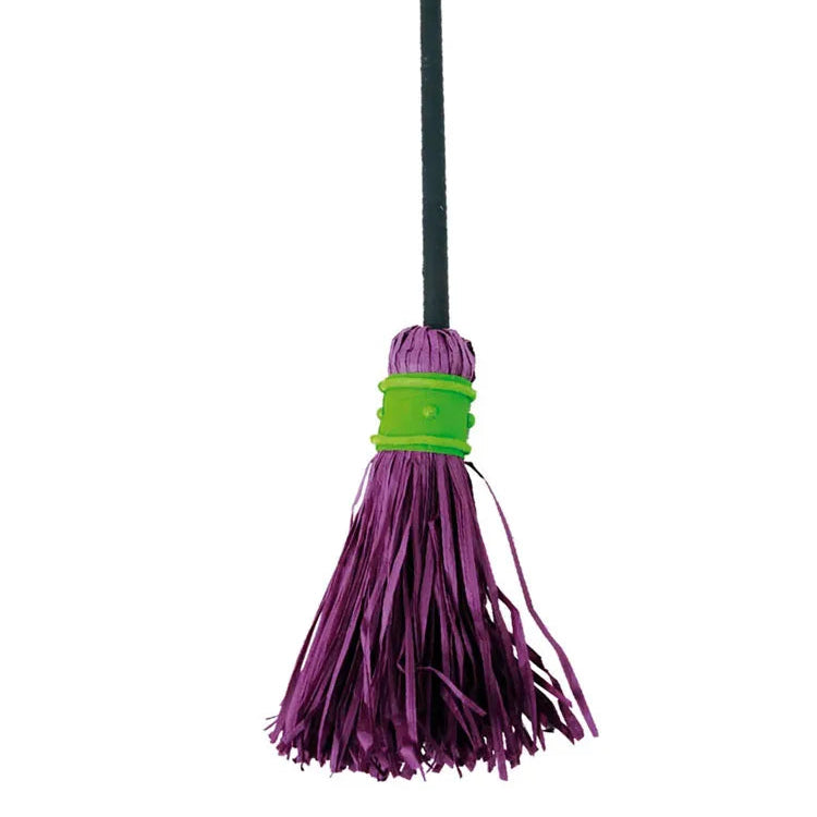 Purple broom with green handle and bristle cover on a white background