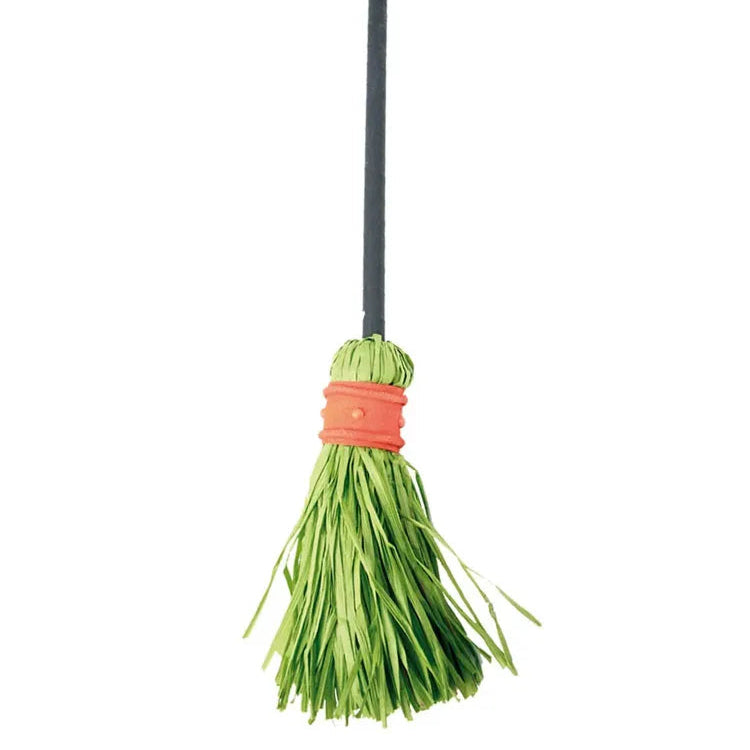 Green broom with a black handle on a white background