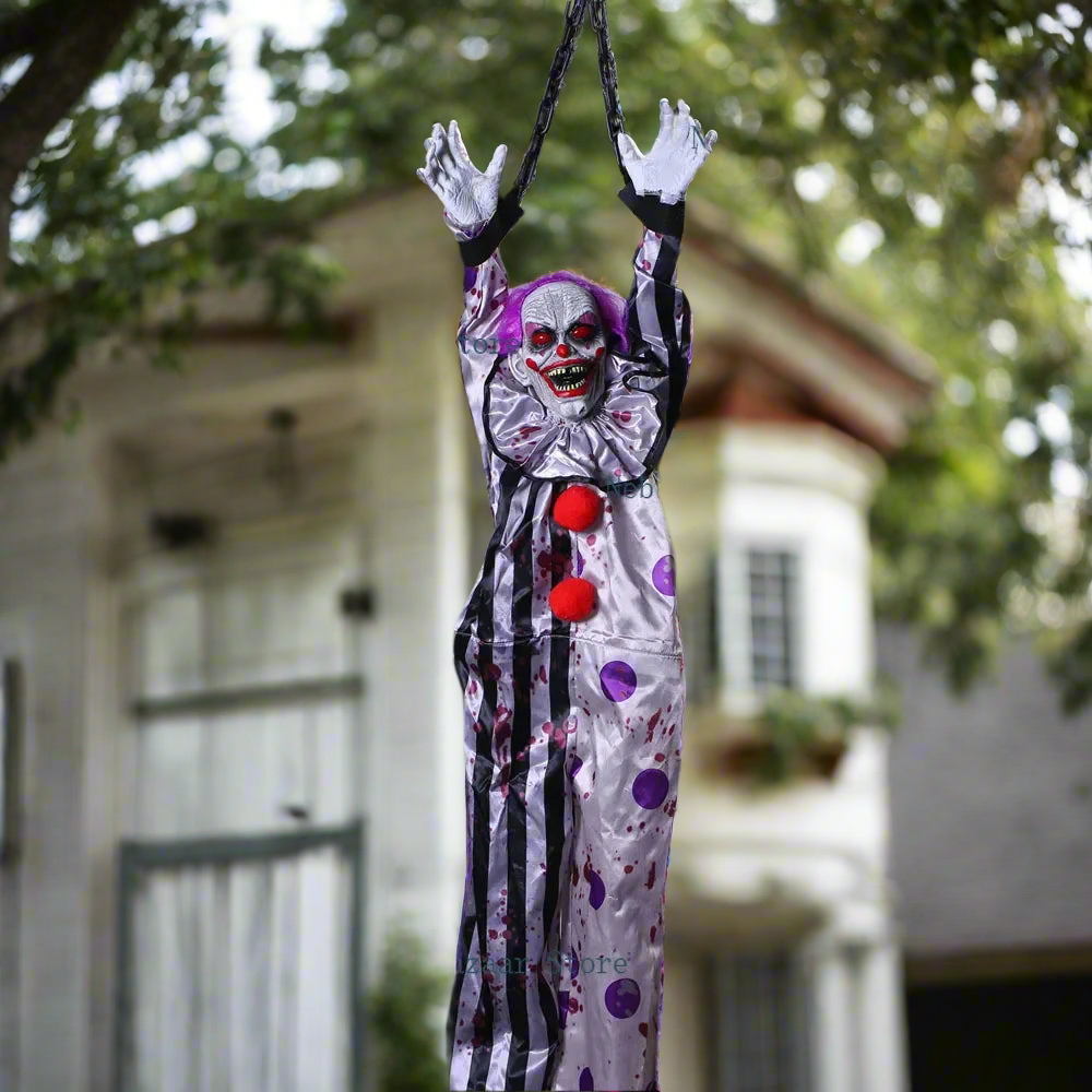 Hanging clown decoration with red balls against a blurred house background