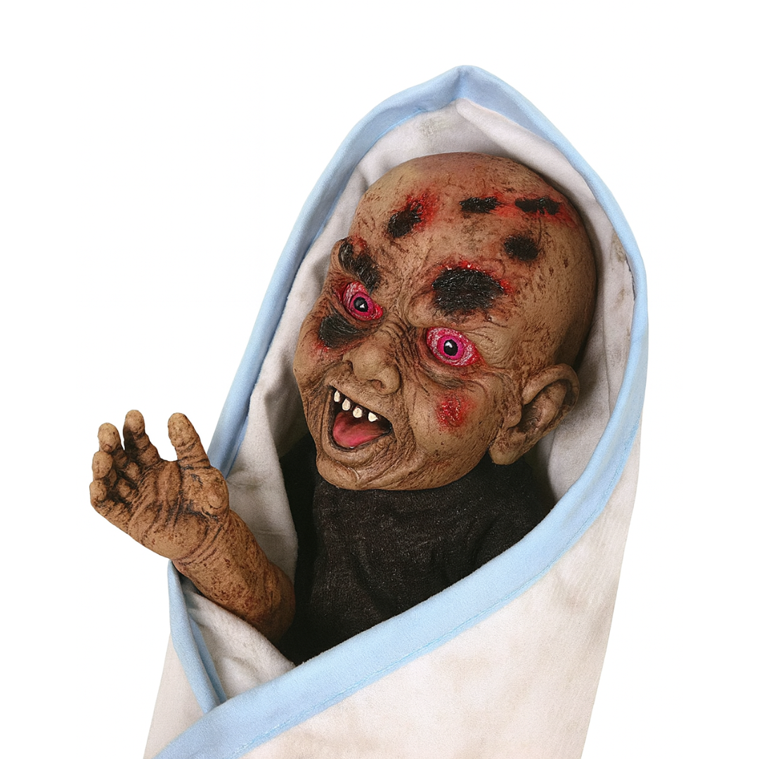 Creepy doll wrapped in a blanket with a white background