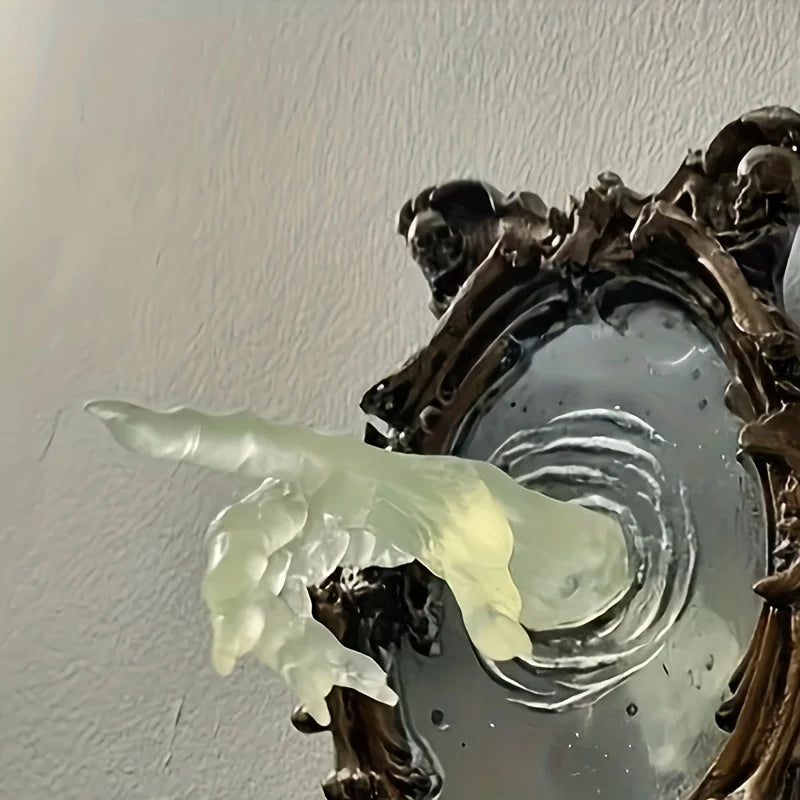 Decorative wall piece with a gold frame and a greenish object inside.