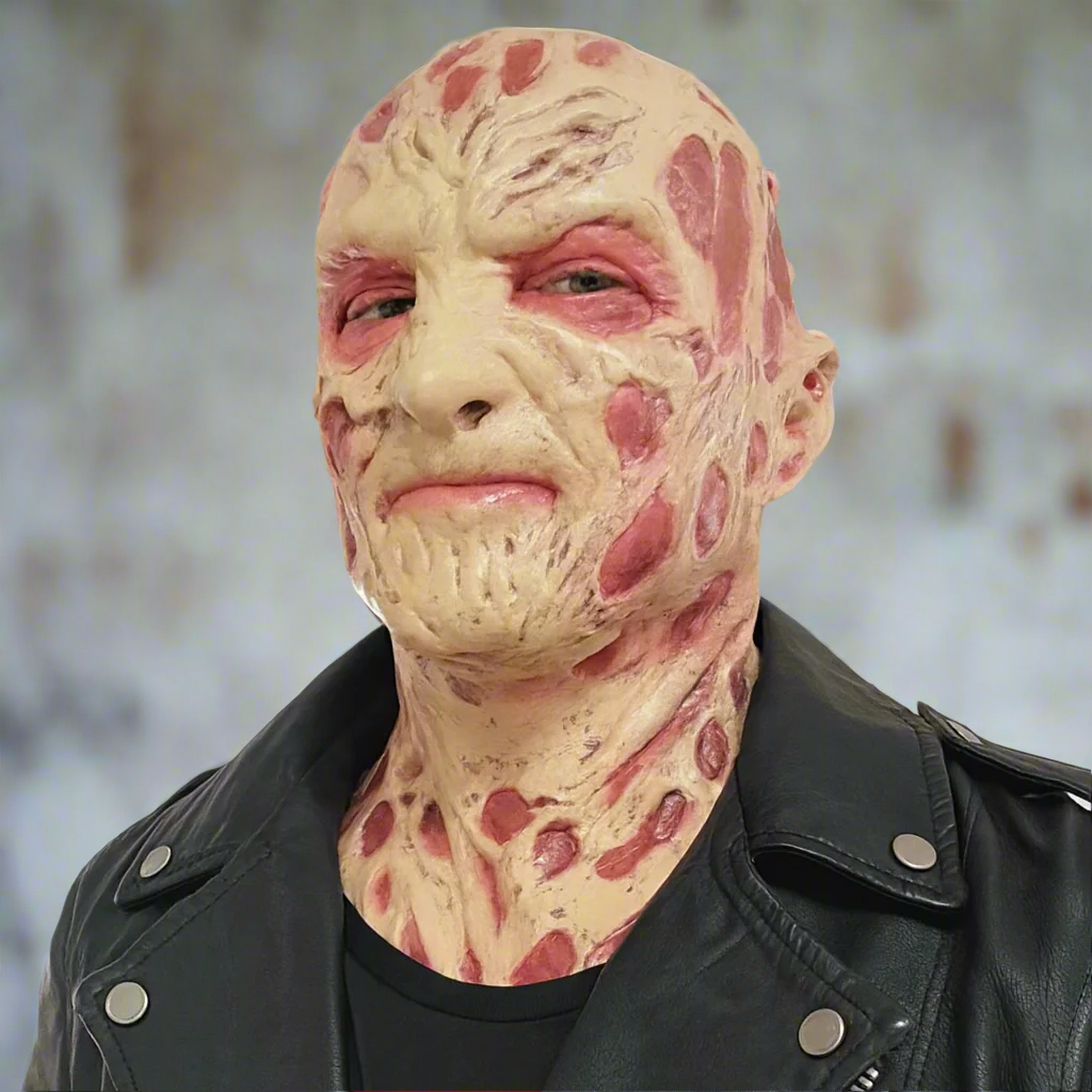 Person wearing a textured mask with a black leather jacket indoors.