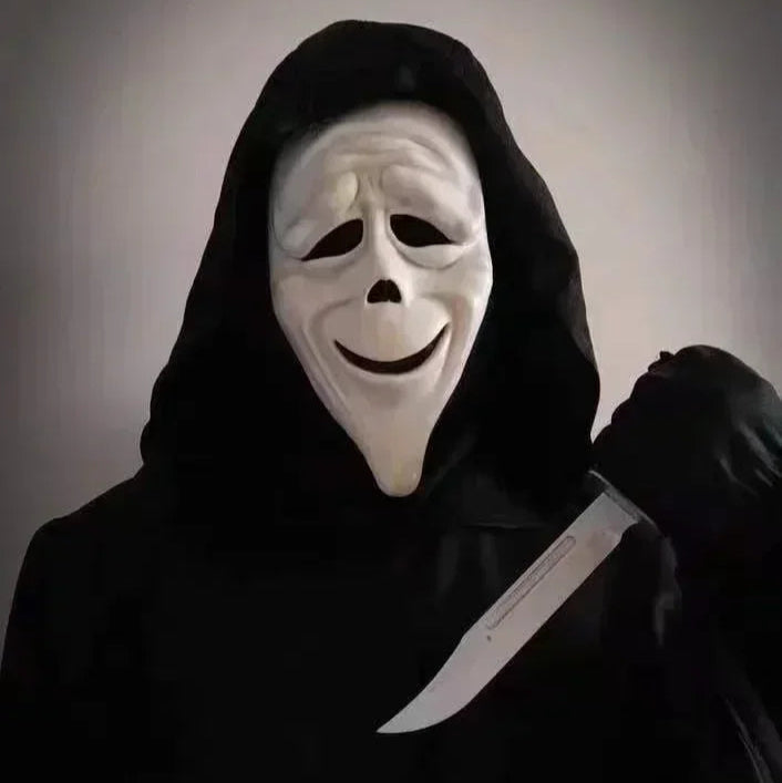 Person wearing a white mask and black hood holding a knife against a dark background
