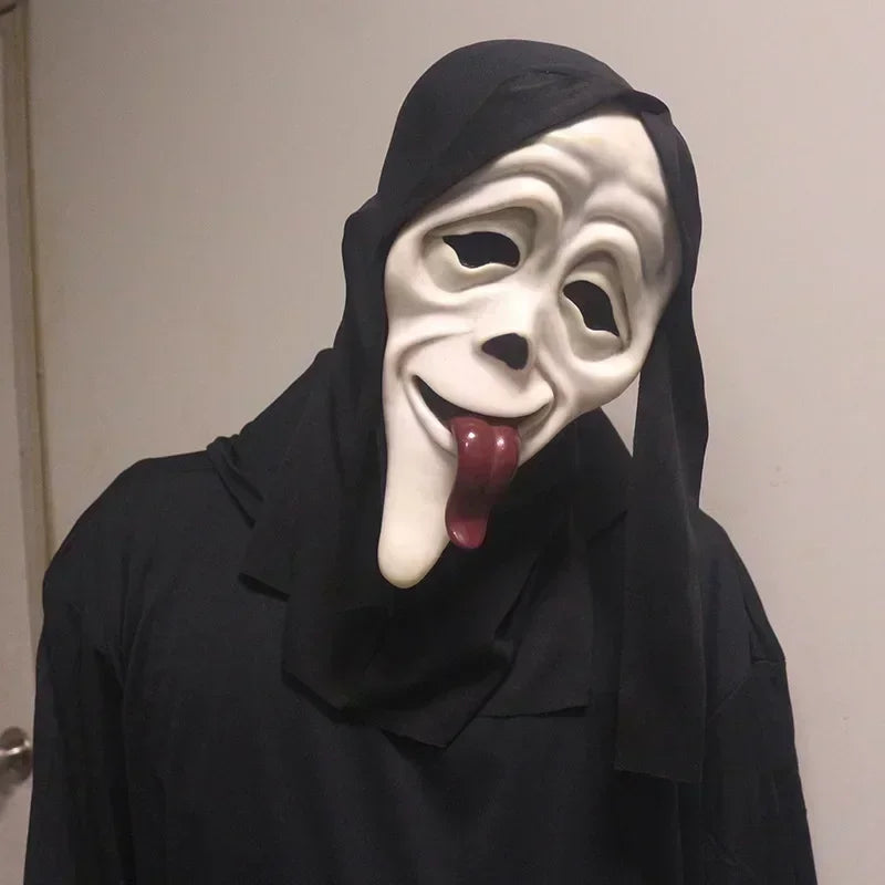 Person wearing a black hooded garment and a white mask with a red tongue sticking out.