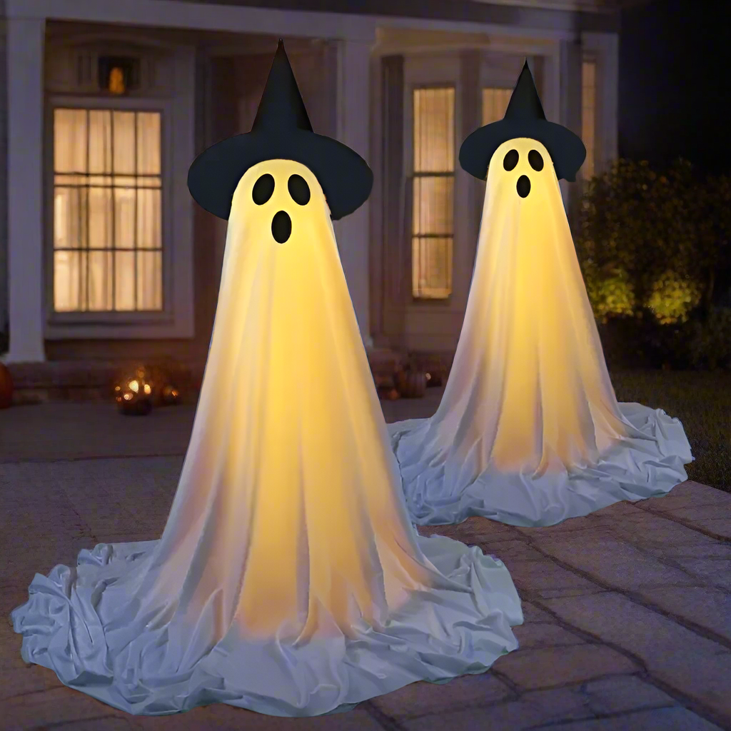 Halloween-themed decorations including ghosts, pumpkins, and scarecrows in a garden setting.