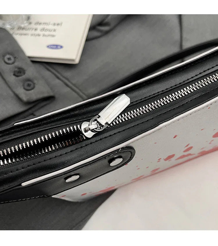 Close-up of a suitcase zipper with a partially visible label on a surface.