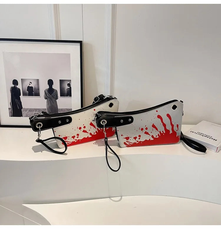 Decorative wall hook with blood-like design on a white surface.