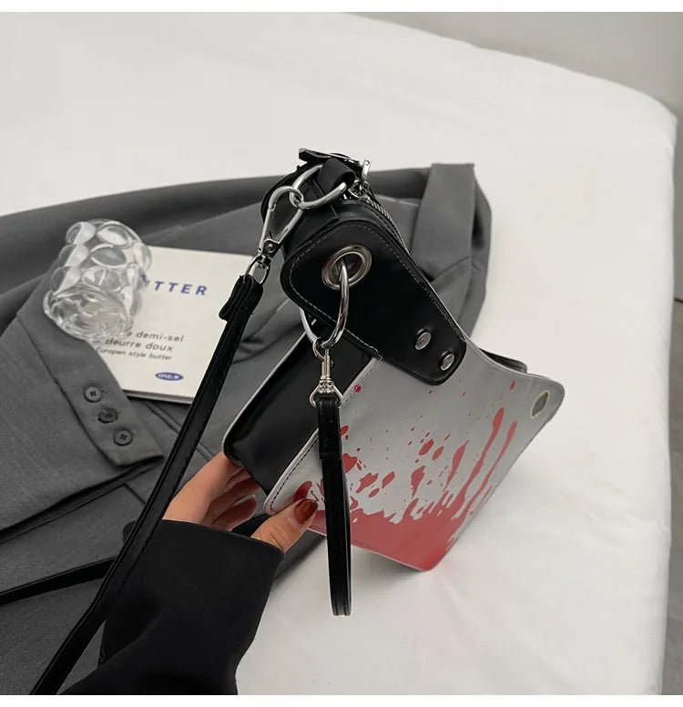 Black handbag with a keychain on a white surface