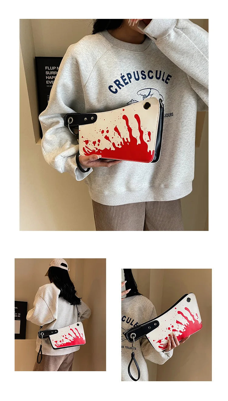 Person wearing a 'Crépuscule' sweater holding a red and white bag with blood-like design.