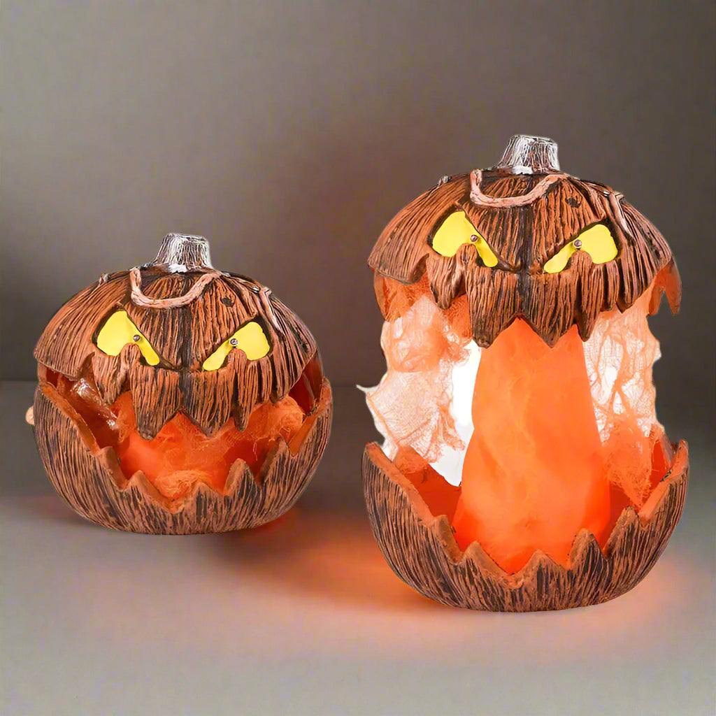 Two Halloween-themed pumpkins with glowing orange interior on a white background