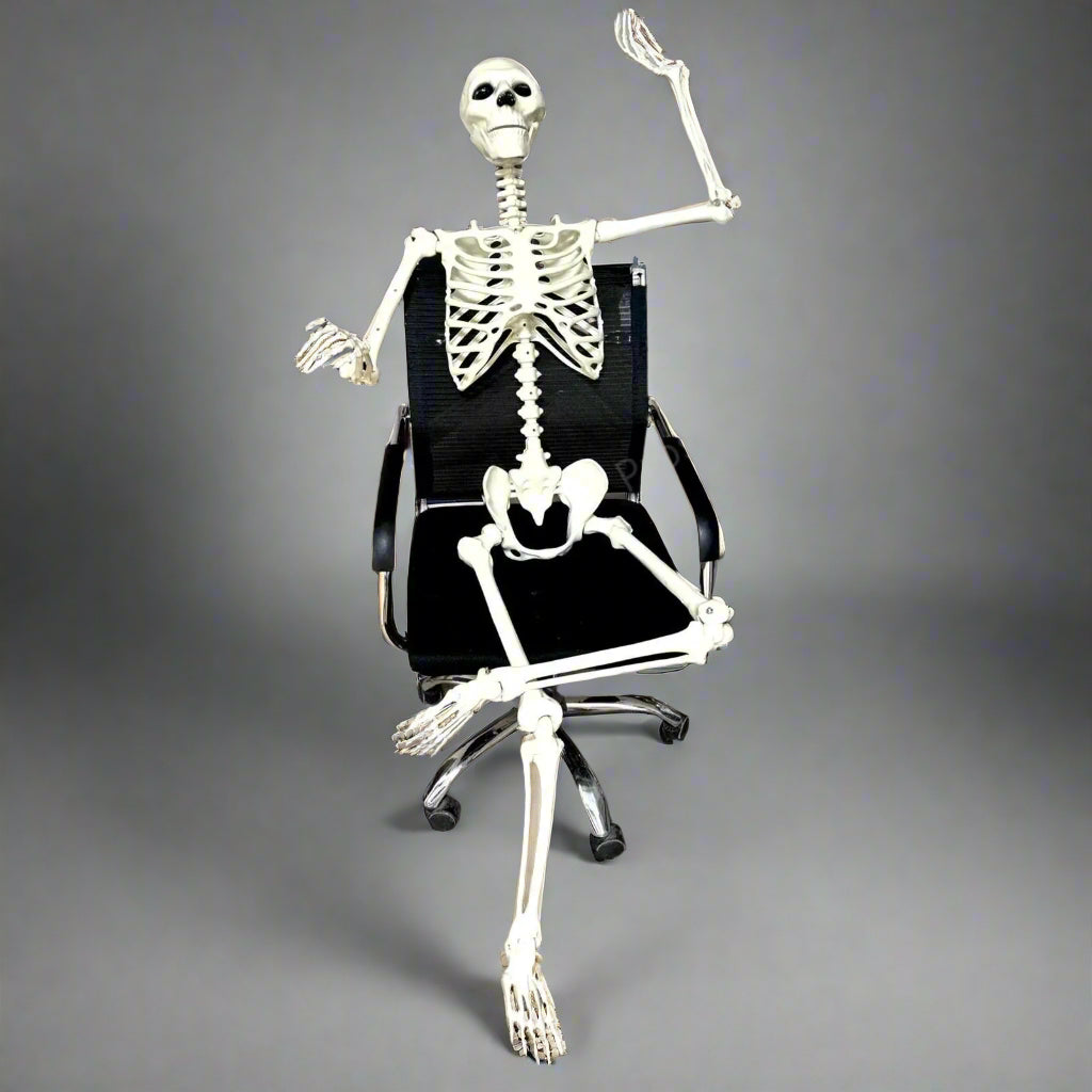 Skeletal figure sitting on a black office chair in an office setting with 'Prosperity' branding.
