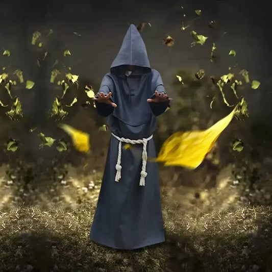 Person in a blue hooded robe standing in a field with yellow leaves falling around them