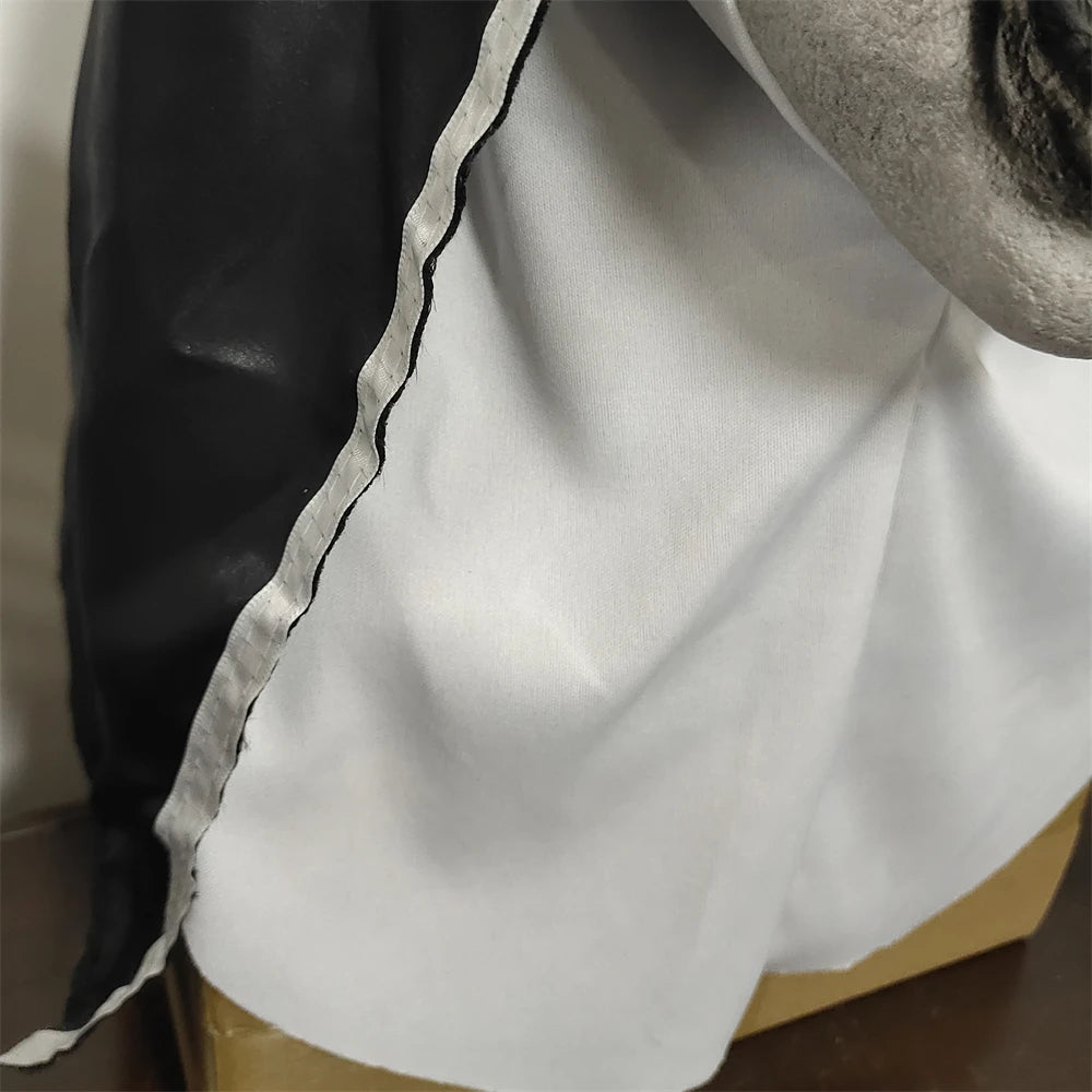 Close-up of a white fabric with black trim on a neutral background