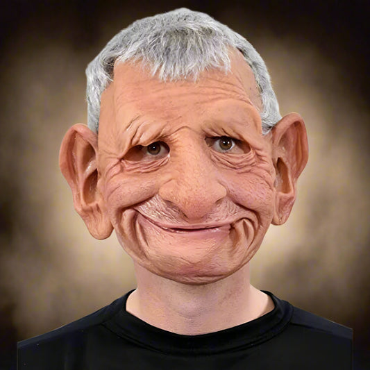 Person wearing a detailed mask with gray hair and a black shirt on a white background