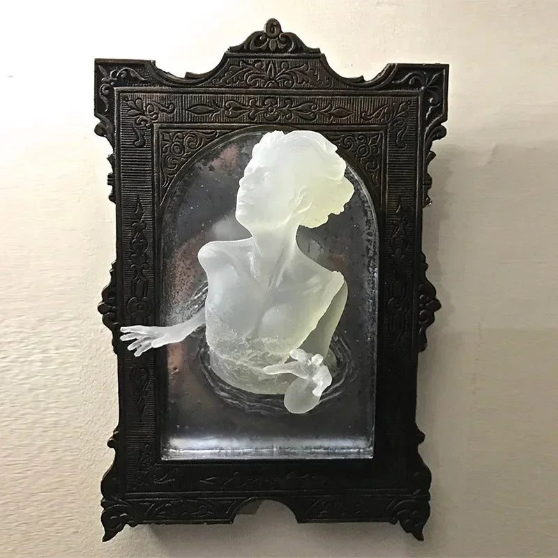 Decorative black frame with a white sculpture of a woman on a beige wall