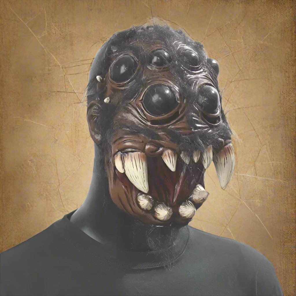 Person wearing a detailed animal mask with large eyes and sharp teeth on a plain background