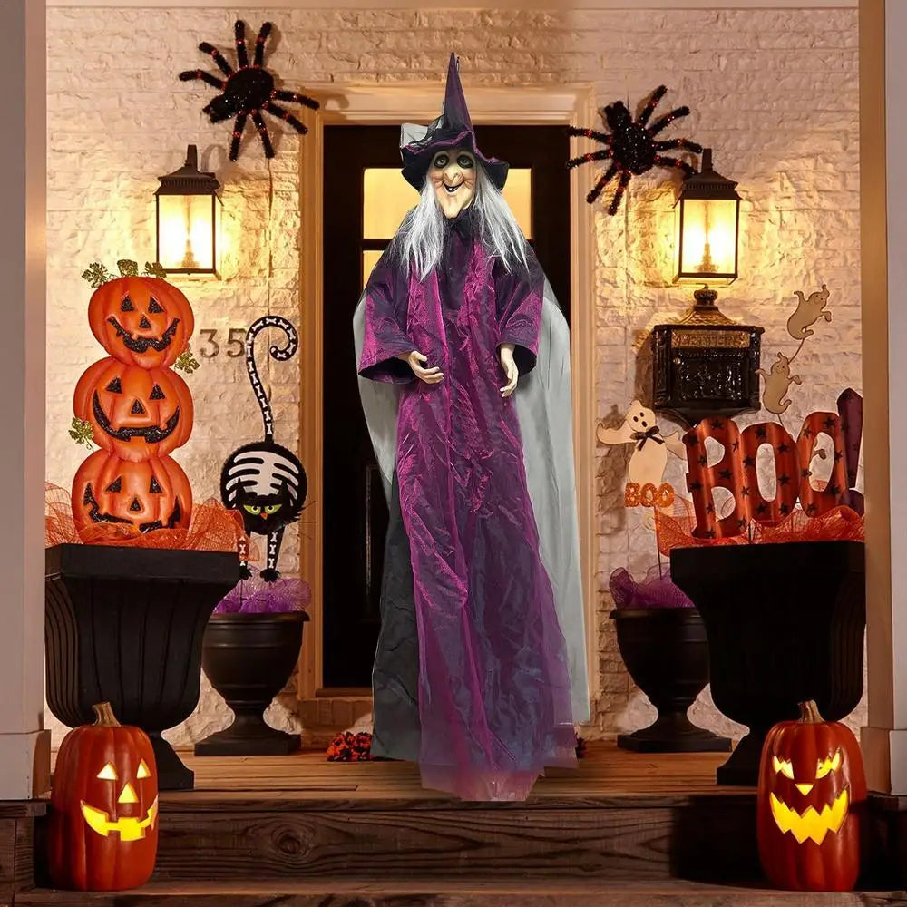 Halloween-themed decoration with a witch figure, pumpkins, and 'BOO!' sign.