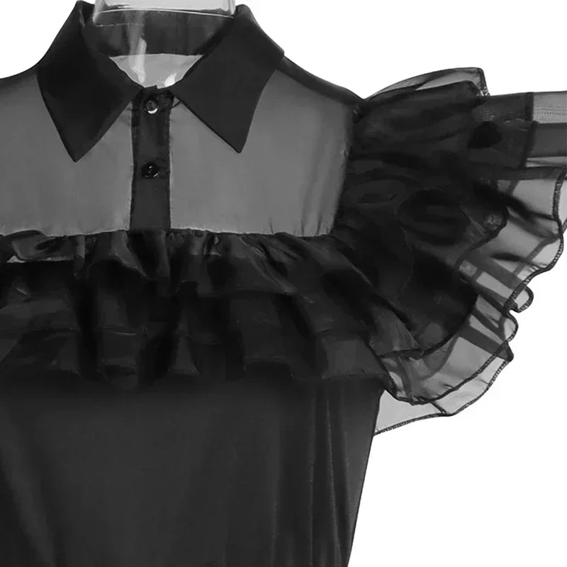 Black blouse with ruffled details on a white background