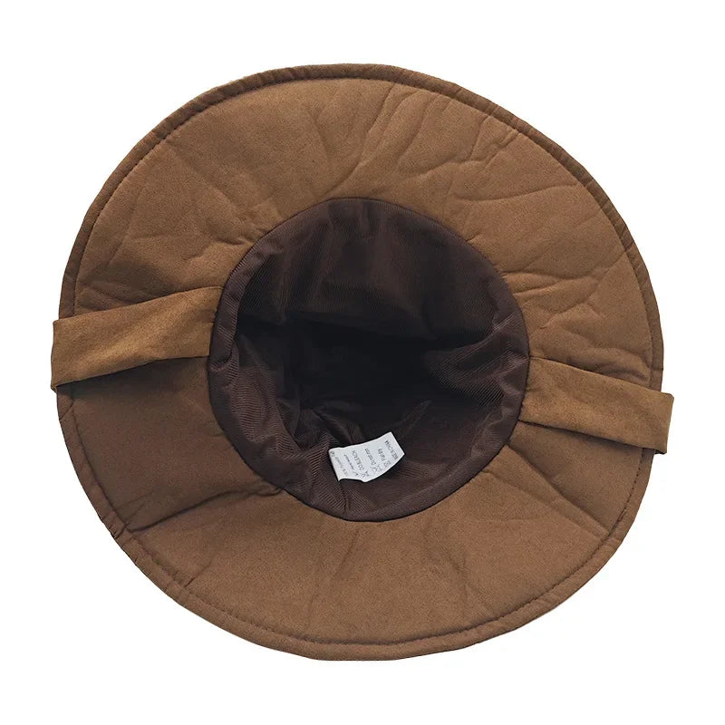 Brown quilted hat with a visible brand label on a white background