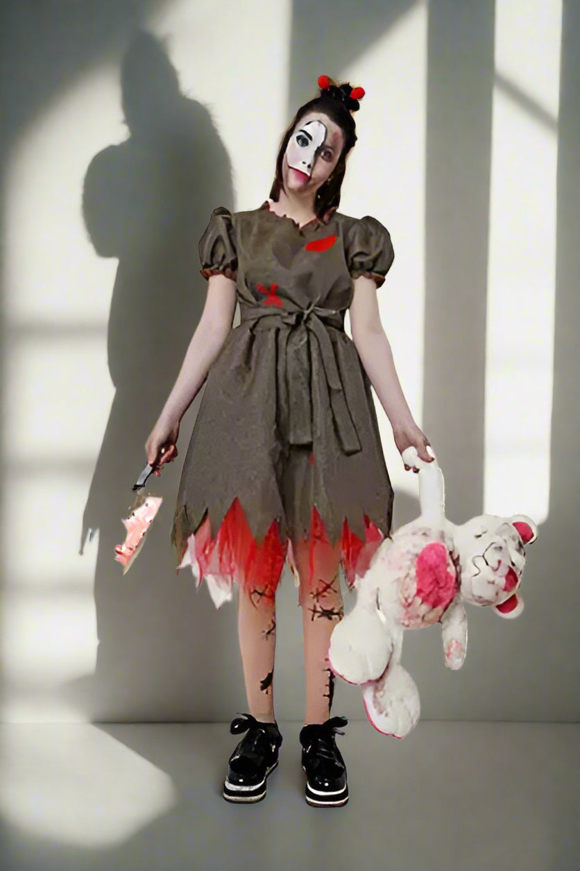 Person in a horror-themed costume with a dress, boots, and holding a teddy bear.